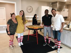 Group in RMHC kitchen wearing striped socks