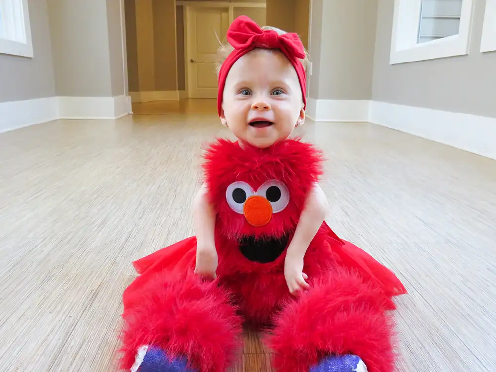 young girl in a fluffy red Elmo dress